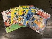 All five bagged Walt Disney Gladstone comic books fanned out on table