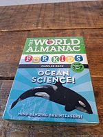 Front of boxed Ocean Science Puzzler Deck featuring orca image and age range