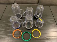 Top view of six blender cups, three comfort rings, two blade bases