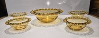 Full view of amber glass serving bowl with four matching small bowls