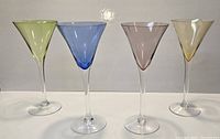 Group shot of four colored martini glasses
