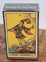 Front of sealed Smith-Waite Centennial Tarot Deck showing ‘The Fool’ card illustration