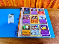 Open binder showing first sleeve of nine Pokémon cards