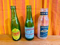 Three bottles front view showing labels and glass colours
