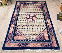 Full view of the hand-knotted Peking carpet showing entire design and fringe