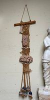 Full view of wall hanging showing jute, terracotta plaques, clay weights, wooden dowel