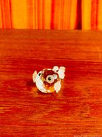 front angled view of Swarovski crystal goldfish on wood surface