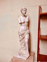 Full front view of the cast Venus de Milo statue showing overall form and base