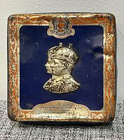 Front of tin showing portrait, crest, border and inscription