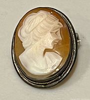 Front view of carved shell cameo in silver frame