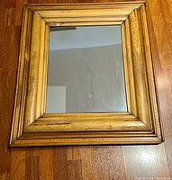 Full view of mirror lying flat showing frame and glass