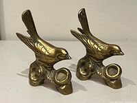 pair of brass sparrow figurines front view