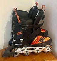 Side view of both skates showing boot graphics, wheels and frame