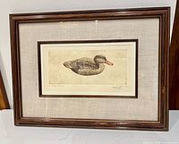 Full view of framed colored etching in wood frame