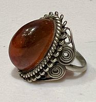 Side view showing amber cabochon and filigree bezel