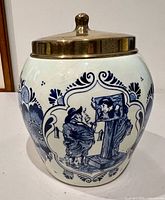 Front view showing painted scene and brass lid