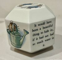 Side view showing Peter Rabbit behind watering can and story text