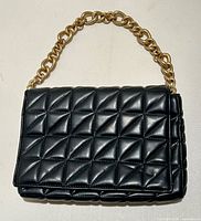 Front view showing quilted pattern and chain handle