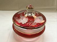 Full view of ruby red etched glass candy dish with lid in place