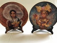 Front view of both Doulton Festival Children plates on stands