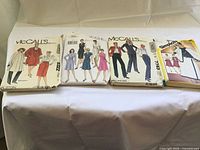 Four sewing pattern envelopes laid out