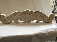 Front view showing carved shell and scroll design of plaque