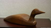 Side view of full carved wooden duck decoy