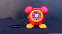 Front view of Disney Mickey Mouse telephone showing full shape.