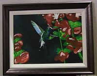 Framed painting showing hummingbird and flowers