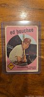 Front of 1959 Topps Ed Bouchee card inside top loader