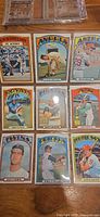 Nine 1972 Topps cards in plastic sheet