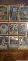 Full view of nine 1972 Topps baseball cards in plastic sheet