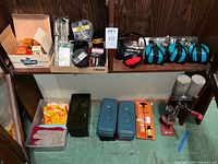 Overall view showing reloading press, ear muffs, ammo can, tool boxes, cleaning kit and supplies