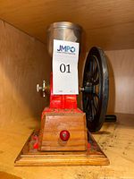 front view showing hopper, body, wood base