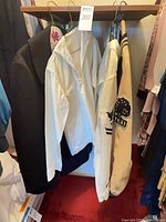 Closet view showing peacoat, one sailor tunic, varsity jacket
