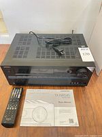 Front view of Onkyo TX-NR545 receiver, remote, manual
