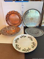 Group of five platters showing materials and motifs