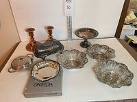 Group shot of all silverplated items including bowls, dishes, candlesticks, Oneida box