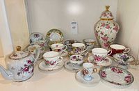 Full lot showing teapot, ginger jar, multiple teacup sets and plates