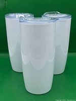 three white tumblers front view
