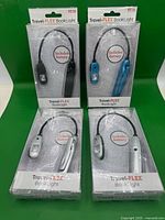 All four sealed Travel-FLEX book lights in packaging