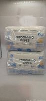 Front view of two grooming wipe packs showing label and capacity