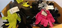 Open box filled to top with assorted knit gloves showing various colors and attached tags