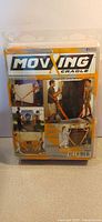 Front of sealed Moving Cradle kit packaging with images showing use