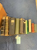 Full lineup of eleven multilingual books showing spines and size comparison