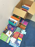 Books laid out on blanket and inside box