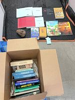 Books laid out and box with additional volumes