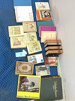 All books laid out on blanket showing variety and quantity