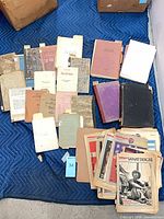 Group view showing entire lot spread on blanket; variety of magazines and booklets visible