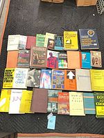 Overhead view showing entire grouping of roughly thirty books arranged in four rows